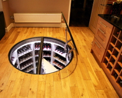 Motorised circular glass cellar door