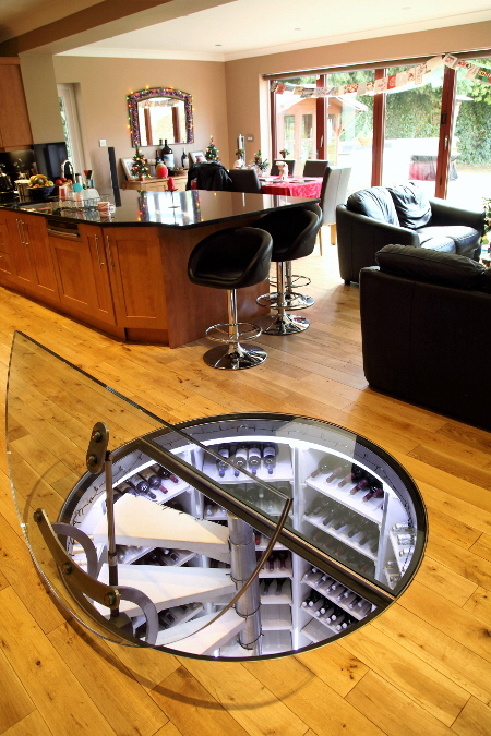 Circular wine cellar by the Stone Cellar Company featuring a motorised glass door